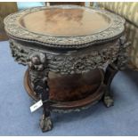 An early 20th century Chinese carved hardwood two tier table, diameter 64cm, height 56cm