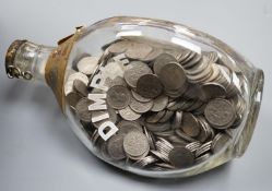 A large bag of UK pennies, coins and a bottle of sixpences