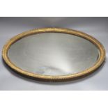 An oval gilt framed wall mirror, 55.5 cm high