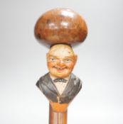 A carved novelty "laughing face" walking stick 82cm