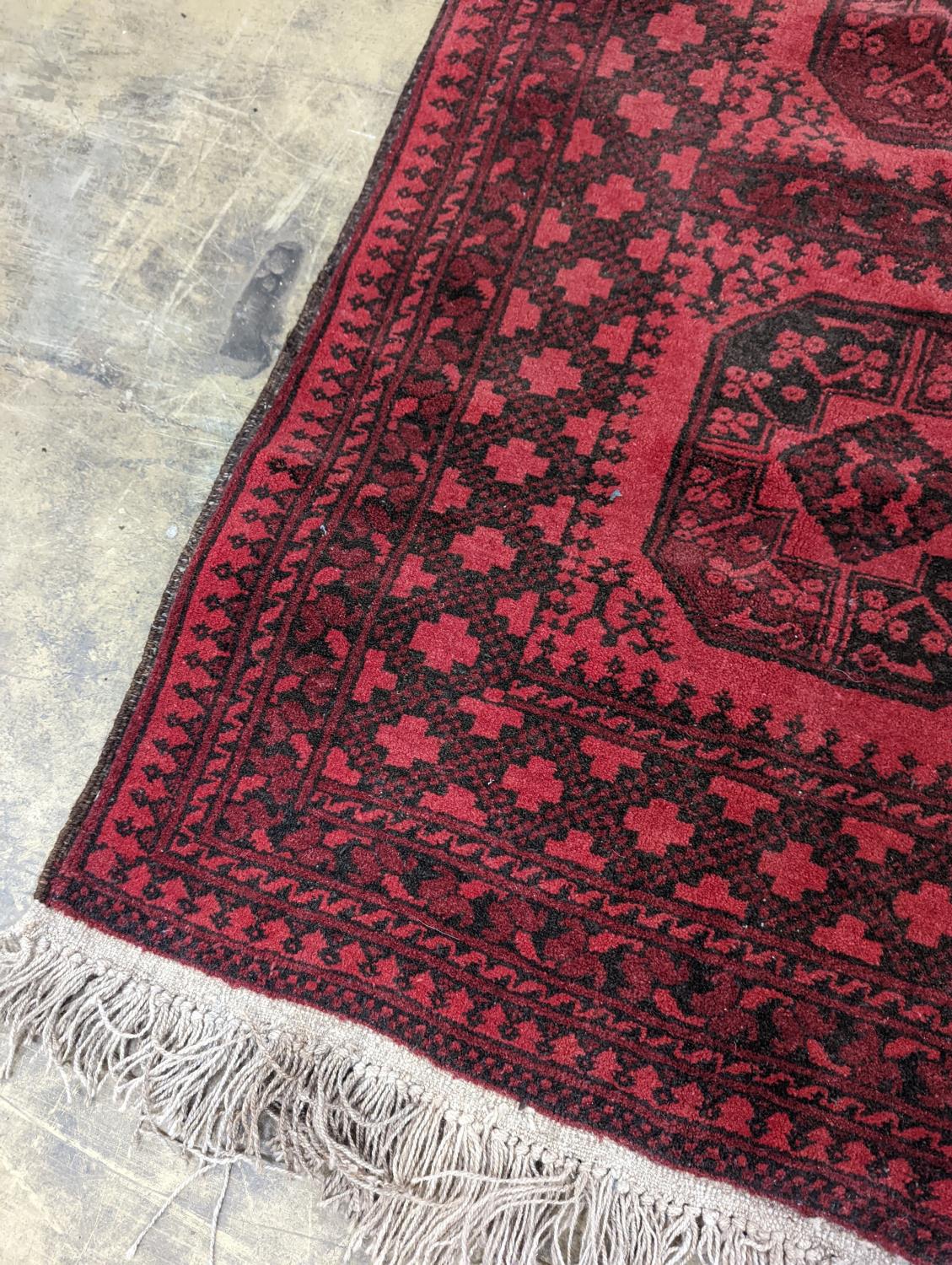 An Afghan red ground rug, 140 x 96cm - Image 3 of 4