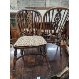 A wheelback Windsor elm and beech chair and six matching single chairs with crinoline stretchers,
