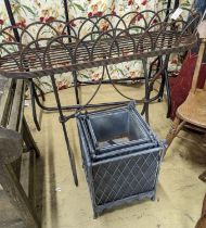 A Victorian style wrought iron pot stand, width 110cm, height 95cm, together with a graduated set of