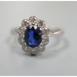 An 18ct and plat. sapphire and diamond set oval cluster ring, size N, gross weight 2.9 grams.