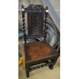 A 17th century oak dining chair, with carved panelled back, solid seat and barley twist