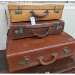 A vintage tan leather case, marked 'Tom Hill SW1' together with two other vintage cases, largest