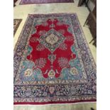 A Tabriz burgundy ground carpet, 350 x 240cm