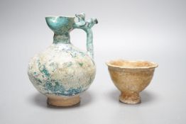 A Kashan turquoise glazed pottery ewer, 14th century, with mineral iridescence and an early