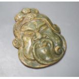 A green hard stone mask carving, height 21cms