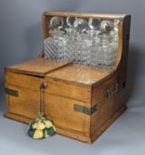 A Victorian brass mounted pale oak tantalus and combined games box, Height 37 cms.