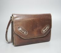 A vintage brown leather handbag stamped "made in Italy by Gucci"