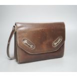 A vintage brown leather handbag stamped "made in Italy by Gucci"