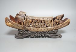 A Chinese horn carving of a junk boat, wood stand, 34cm
