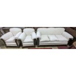 An early 20th century carved mahogany upholstered three piece lounge suite on claw and ball feet,