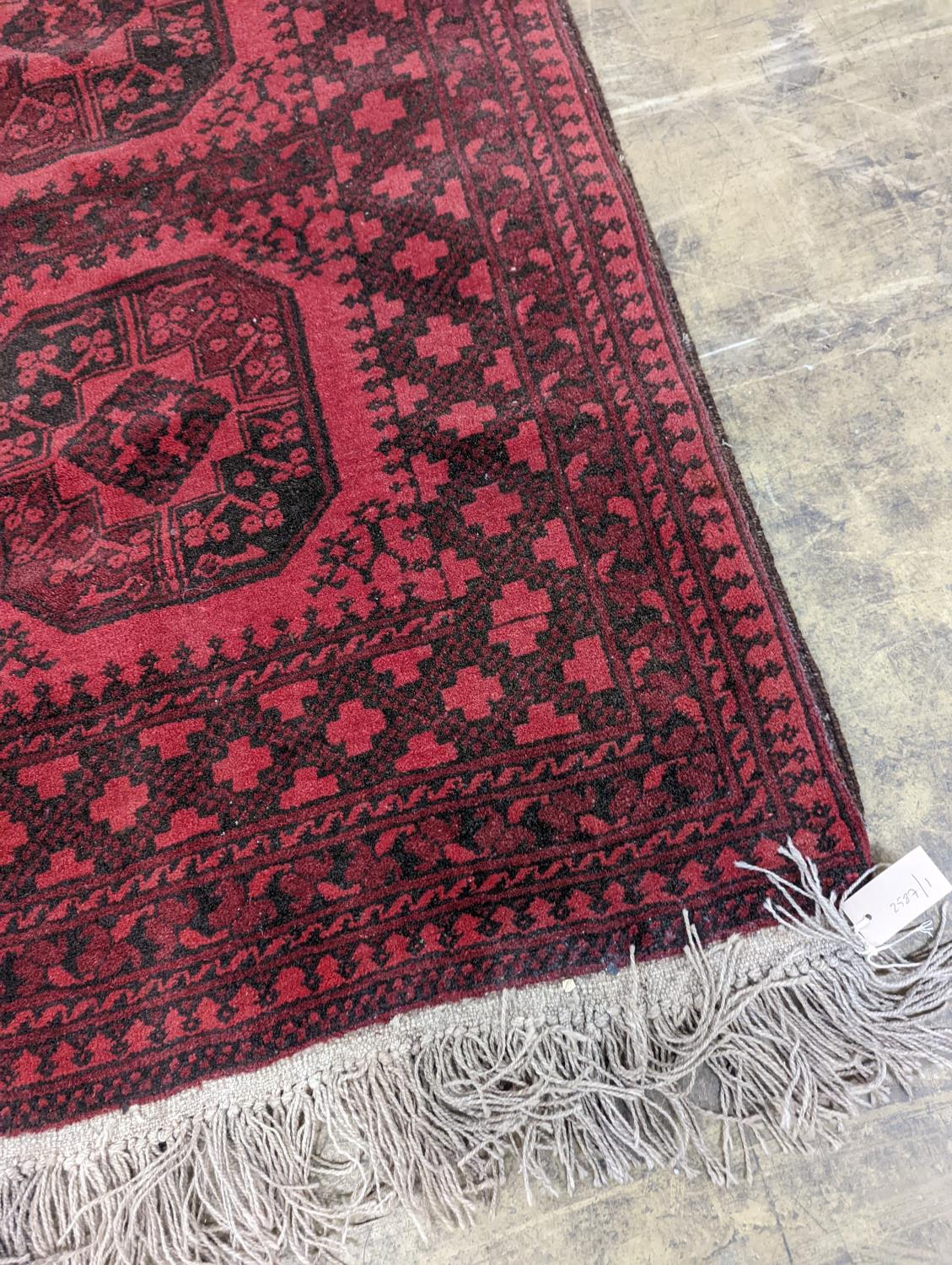 An Afghan red ground rug, 140 x 96cm - Image 2 of 4