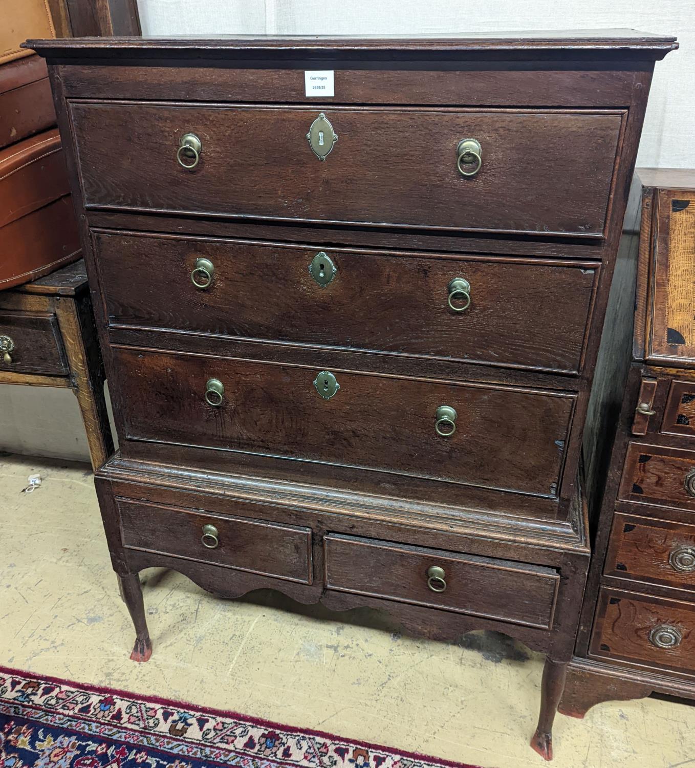 A mid 18th century oak chest on stand, width 89cm, depth 52cm, height 126cm