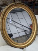 A Victorian oval giltwood and gesso wall mirror, width 80cm, height 94cm