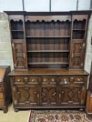 An early 20th century Jacobean revival oak dresser, width 168cm, depth 48cm, height 218cm