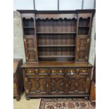 An early 20th century Jacobean revival oak dresser, width 168cm, depth 48cm, height 218cm