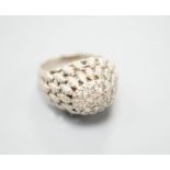 A continental textured white metal and diamond cluster set domed top dress ring, size K/L, gross