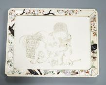 A Japanese ivory tray/plaque, Meiji period, with sunk-in carving of boy with dove, the surround