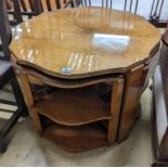 An Art Deco style cross banded walnut nest of tables of circular serpentine form, diameter 72cm,