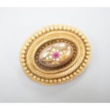 A Victorian yellow metal, ruby? and seed pearl set oval brooch, with glazed back, 43mm, gross weight