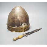 A Middle-Eastern silvered metal and brass helmet and a dagger in sheath