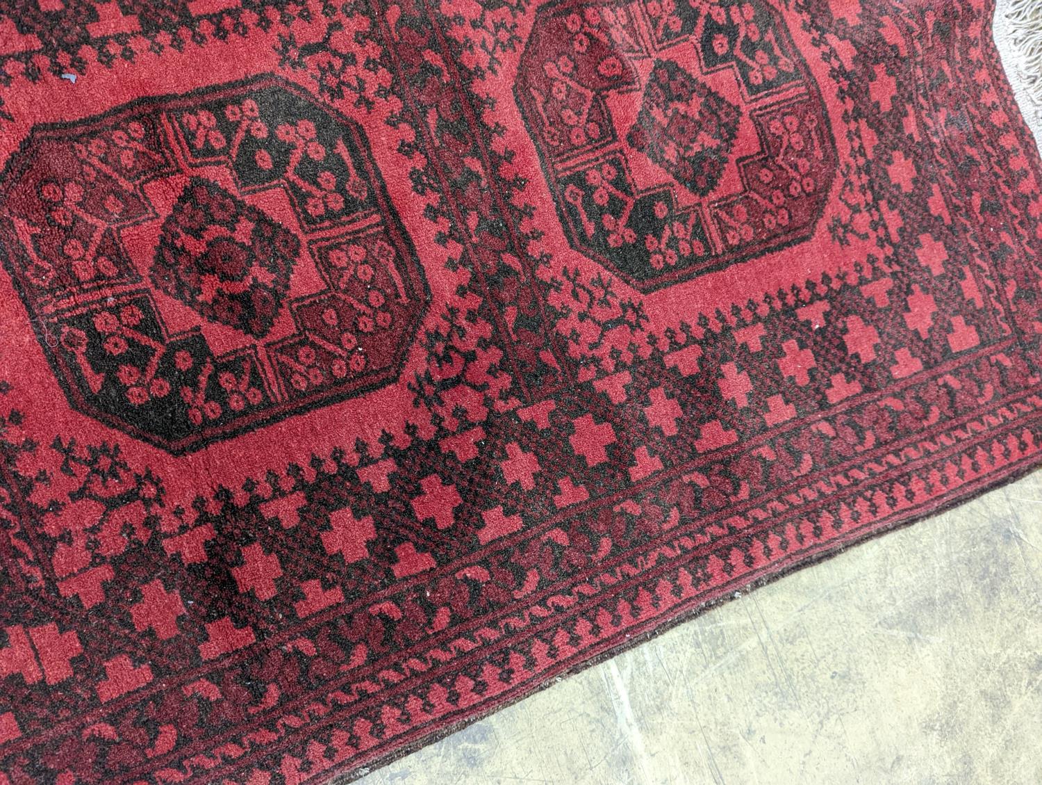 An Afghan red ground rug, 140 x 96cm - Image 4 of 4