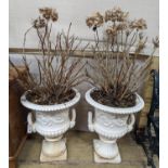 A pair of Victorian style white painted cast metal campana garden urns, height 62cm