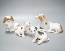 Two Royal Copenhagen figures of dogs and two Bing and Grondahl figures of dogs, largest 23 cms wide