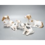 Two Royal Copenhagen figures of dogs and two Bing and Grondahl figures of dogs, largest 23 cms wide