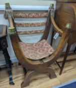 A brass mounted oak folding X framed elbow chair, width 58cm, depth 47cm, height 90cm