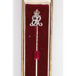 A white gold stick pin with diamond and red enamel monogram ‘’ER’’, beneath a crown, in