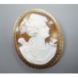A 9ct mounted oval cameo shell brooch, carved with the bust of a lady to sinister, 5cm, gross weight