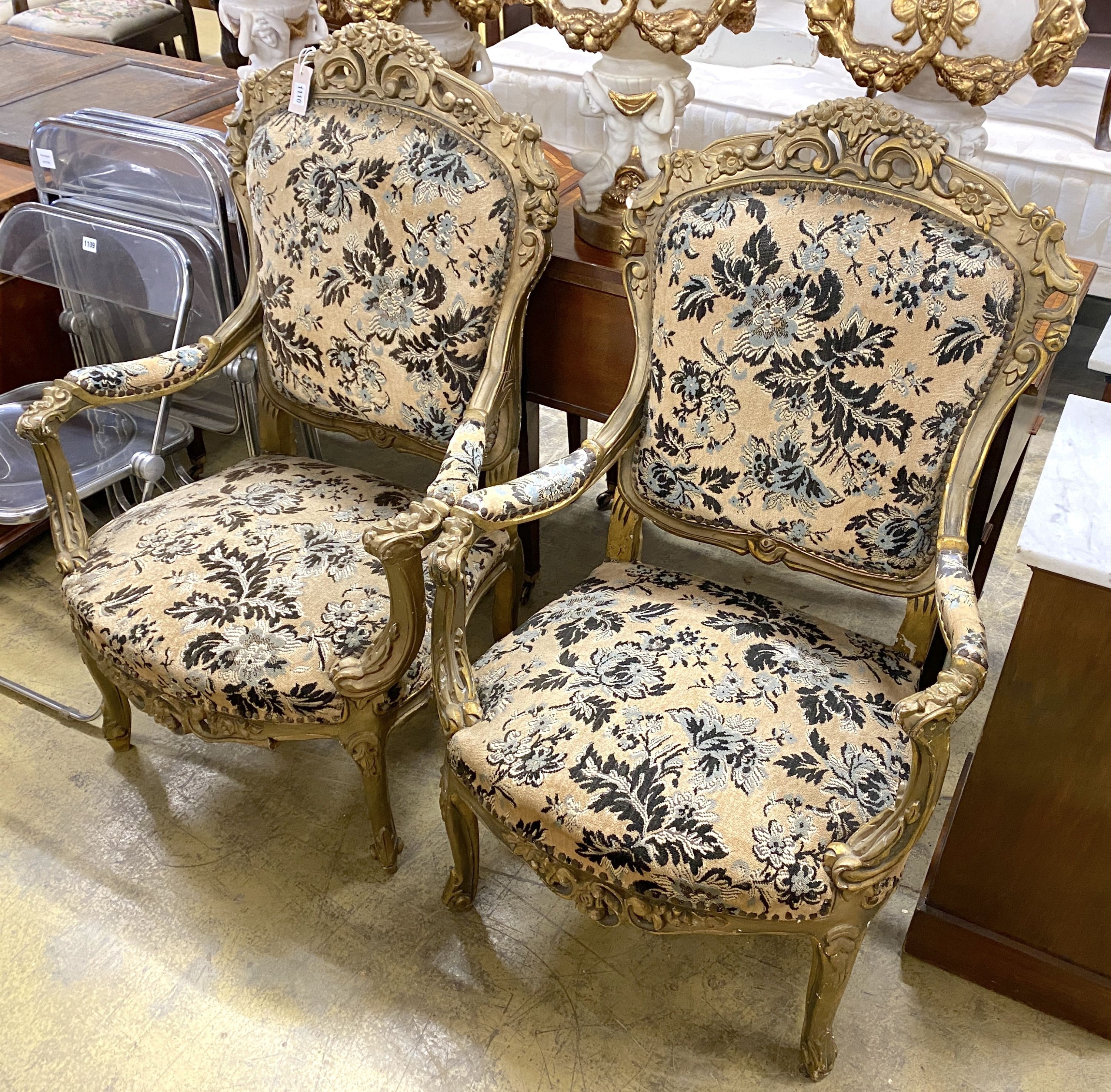 A pair of Louis XVI style carved giltwood upholstered open armchairs, width 72cm, depth 54cm, height