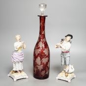 A late 19th century Bohemian wheel engraved ruby glass decanter and a pair of continental