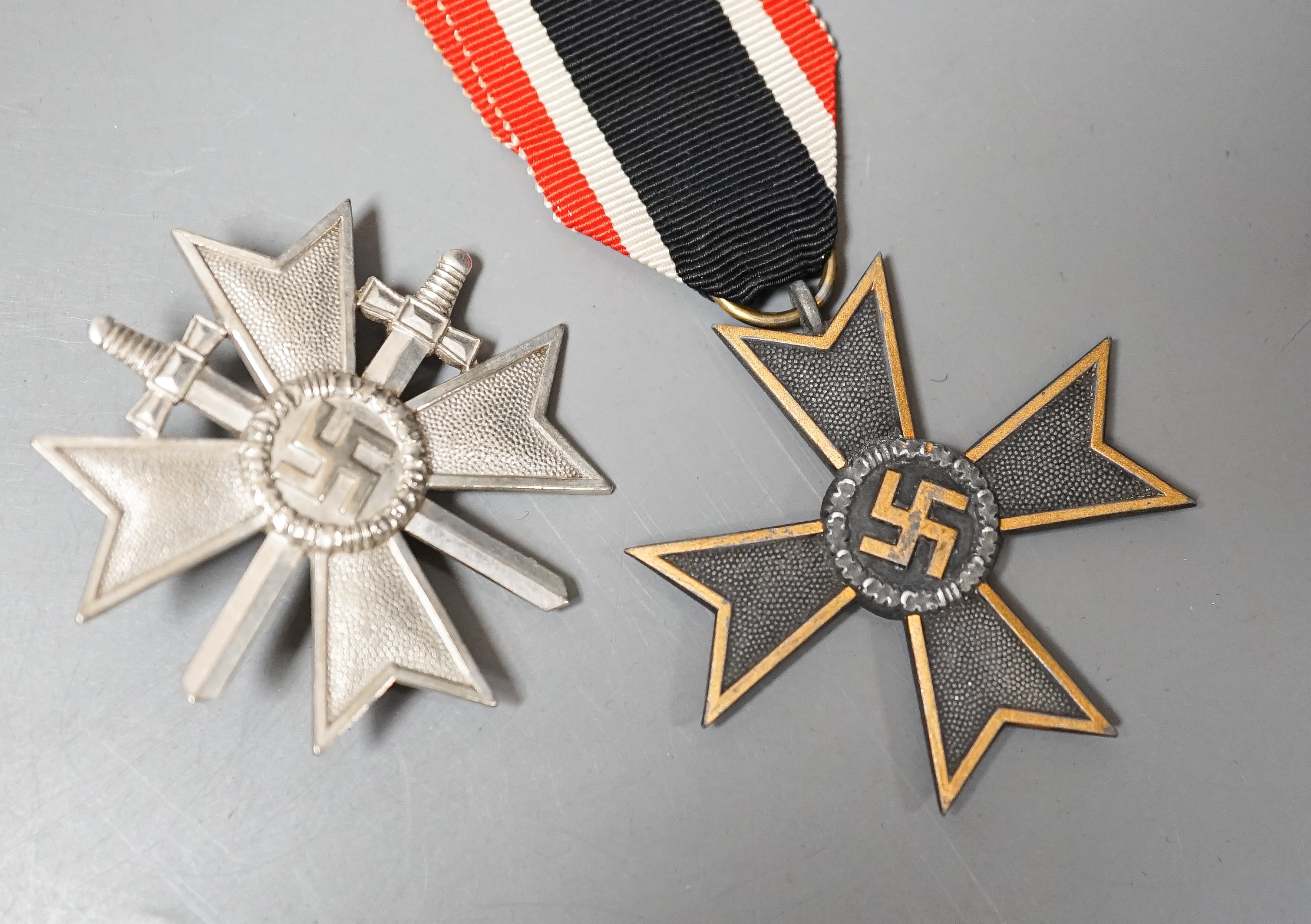 A WW2 German War Merit Cross 1st Class With Swords, stamped 1, a War Merit Cross 2nd Class Without