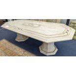 A Travertine marble dining table of elongated ocgtagonal form on twin octagonal column supports,