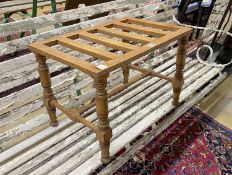 An early 20th century oak luggage stand