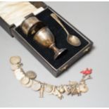 A 1930's cased silver christening set, comprising an egg cup, spoon and napkin ring, together with a