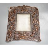 A bronzed copper frame decorated with putti, circa 1900. 28.5cm long