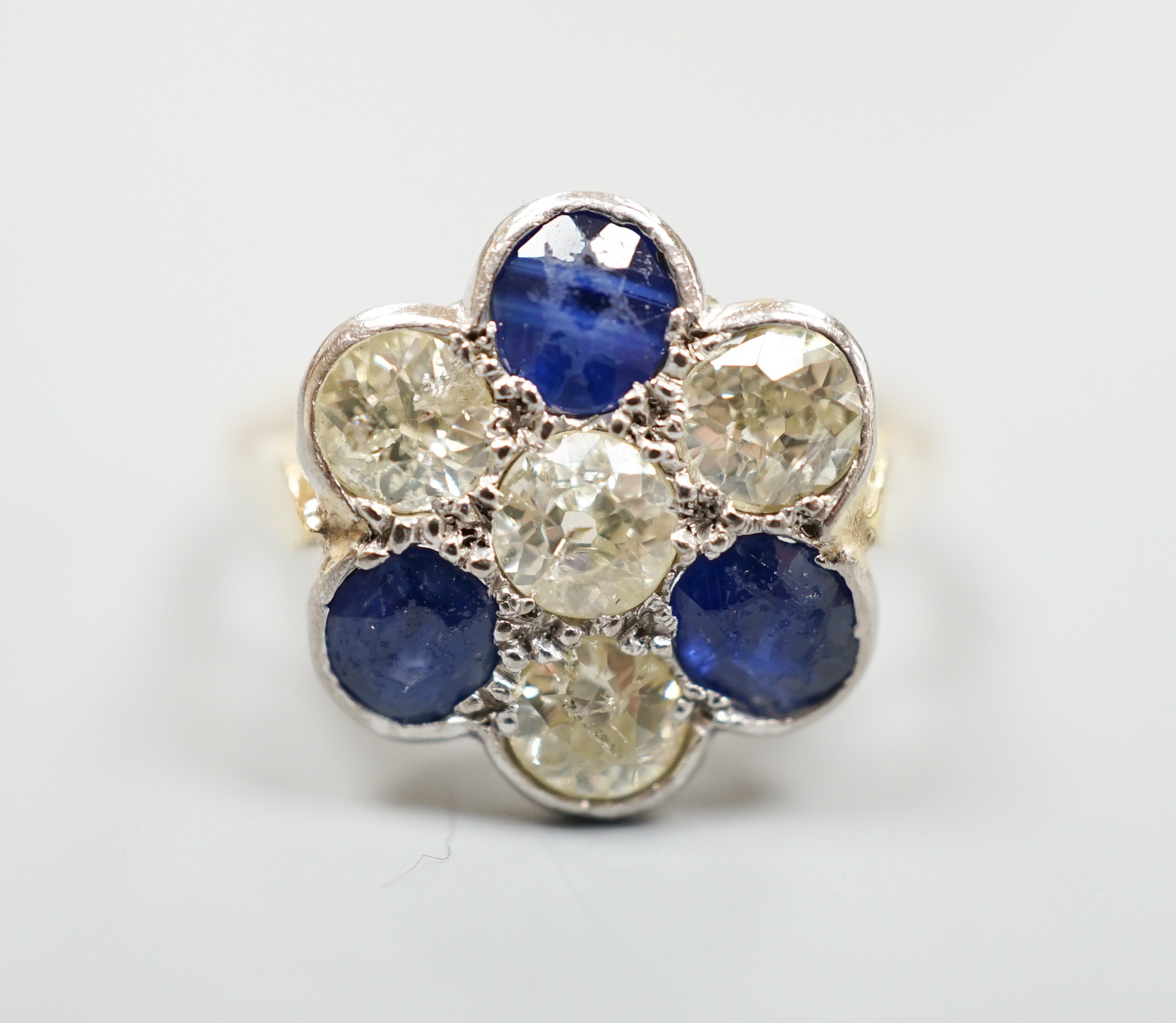 A modern 18ct gold, four stone diamond and three stone sapphire set flower head cluster ring, size - Image 2 of 4