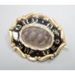 A Victorian yellow metal overlaid and black enamel 'In Memory Of' shaped oval brooch, with central