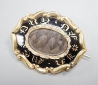 A Victorian yellow metal overlaid and black enamel 'In Memory Of' shaped oval brooch, with central