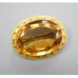 A Victorian yellow metal and citrine set oval brooch, with cannetille work border, 35mm, gross
