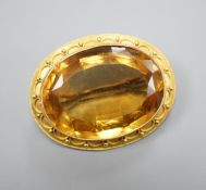 A Victorian yellow metal and citrine set oval brooch, with cannetille work border, 35mm, gross