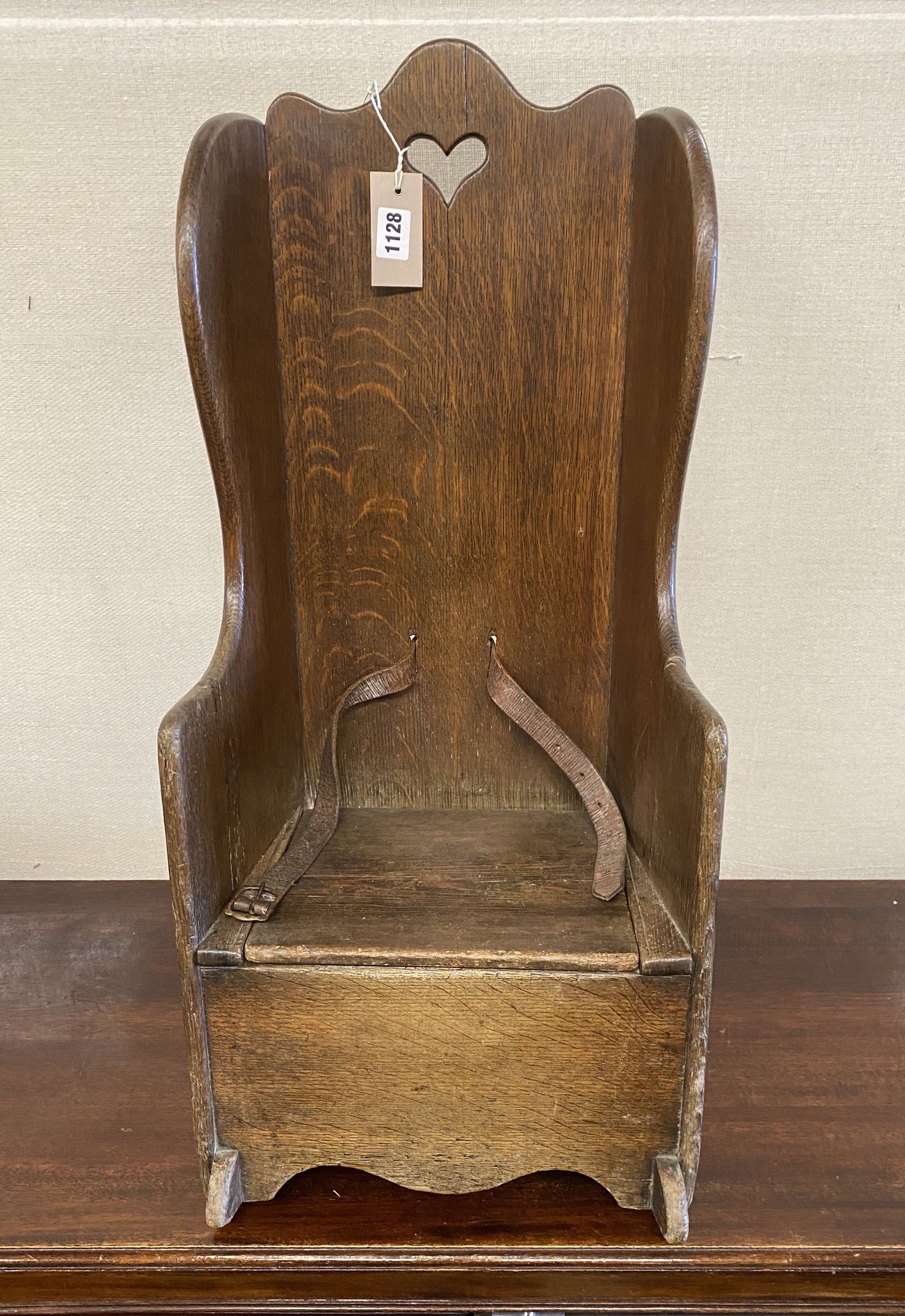 An 18th century oak child's rocking commode chair, width 33cm, depth 50cm, height 70cm