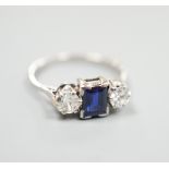 A white metal (stamped plat), sapphire and diamond set three stone ring, size K, gross weight 3.6