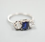 A white metal (stamped plat), sapphire and diamond set three stone ring, size K, gross weight 3.6